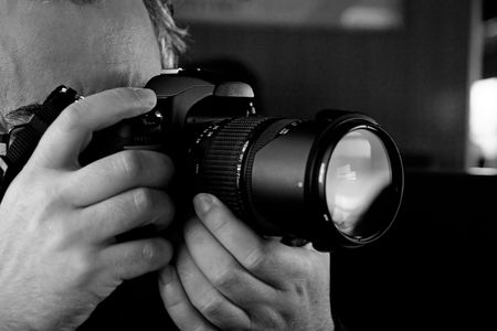 Close up view of a photographer taking a picture with a digital camera.の写真素材