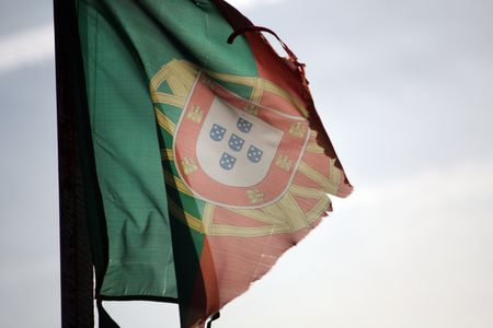 Close view of an old and ripped portuguese flag.の写真素材