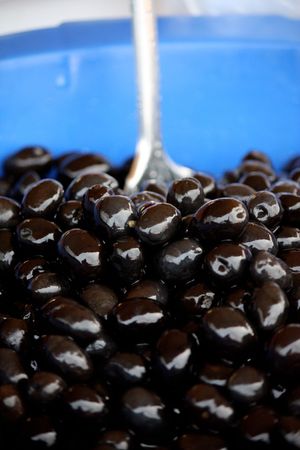 Bucket of black olives at sale on the street market.の写真素材