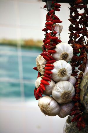 View on the street market some hanging garlic and red pepper.の写真素材