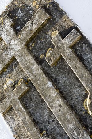Close up detail of three church crosses on a wall.