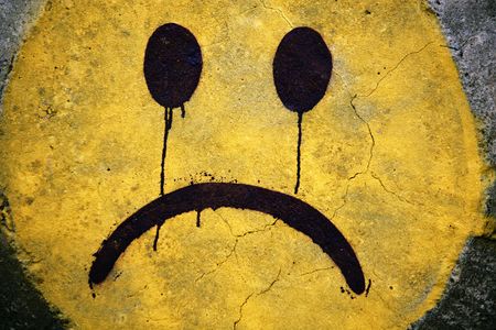 Close up detail of a painted smiley on a concrete rock.の写真素材