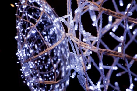 Close detail view of a ball of wire and light reflected on a mirror.
