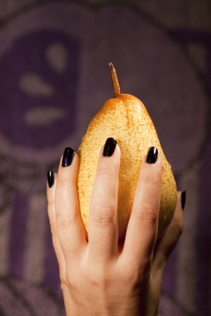 View of a woman's hand holding a wet pear.の写真素材