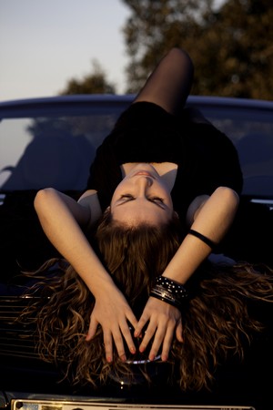 view of a beautiful woman on top of a sports car.の写真素材