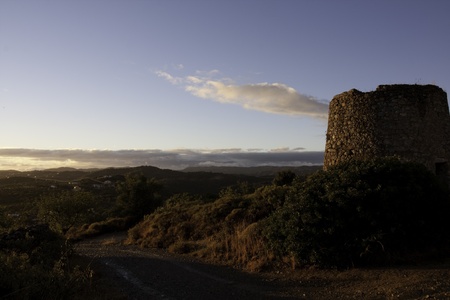 View of a abandoned windmill construction on a beautiful landscape.の写真素材