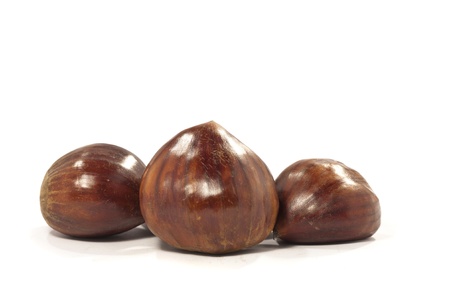 close view detail of a bunch of chestnuts isolated on a white background.の写真素材