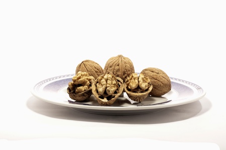 close view detail of  some walnuts on a plate isolated on a white background.の写真素材
