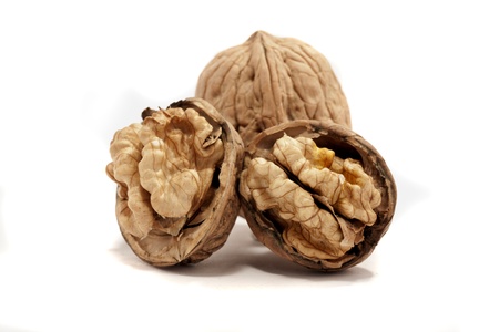 close view detail of  some walnuts  isolated on a white background.