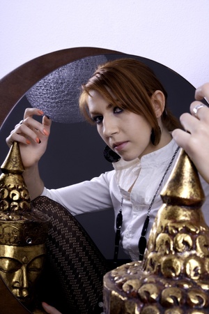 View of a beautiful woman looking at her on a mirror.の写真素材