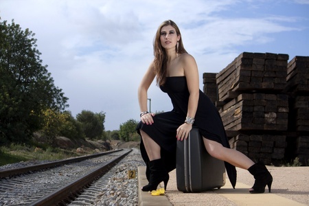 View of a beautiful woman with black dress upset with not catching the trainの写真素材