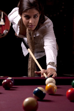 Detail view of a girl next to a snooker table.