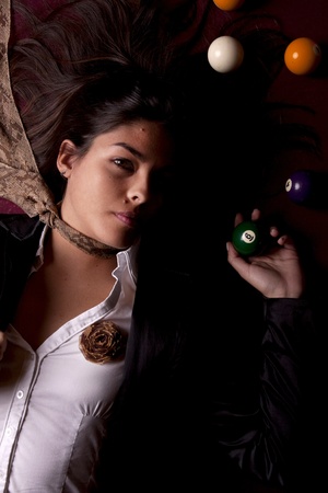 Detail view of a girl next to a snooker table.