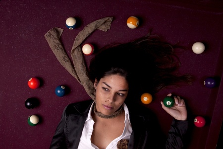 Detail view of a girl next to a snooker table.