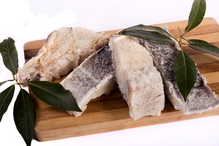 View of a bunch of sliced salted codfish isolated on a white background.の写真素材