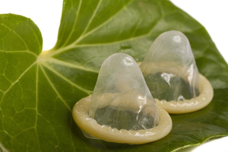Close view of a condom isolated on a white background.の写真素材