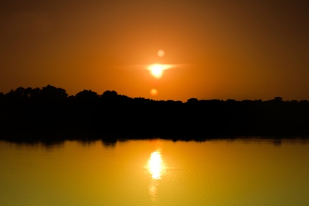 View of a beautiful and vibrant sunset with reflection on the water.