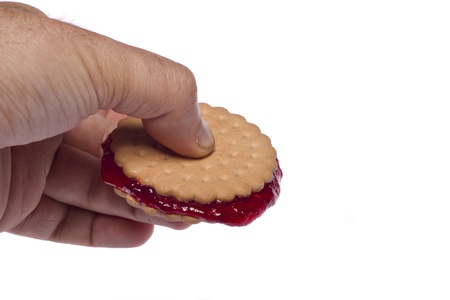 View of a round biscuit isolated on a white background with berry jam.の写真素材