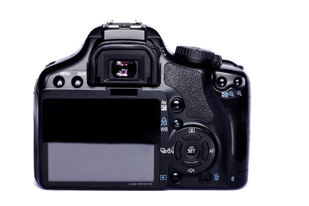 Close view of a modern photographic DSLR camera isolated on a white background.