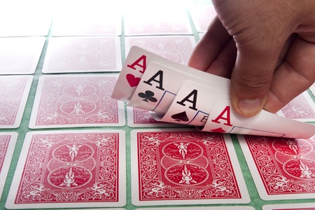 Close up view of a bunch of flipped playing cards spread on a green cloth table.のeditorial素材