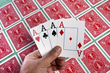 Close up view of a bunch of flipped playing cards spread on a green cloth table.のeditorial素材