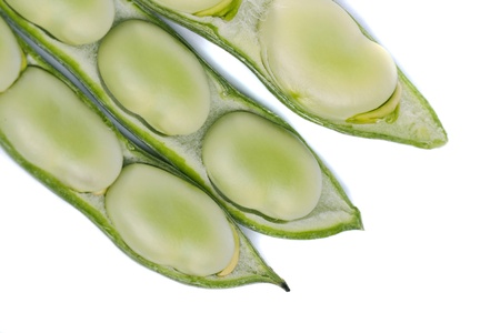Close up view of some broad beans isolated on a white background.