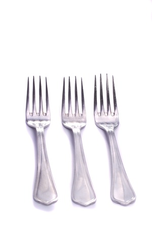 Close up view detail of some forks isolated on a white background.