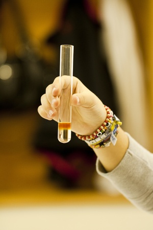 Close up view of a student of chemistry holding a test tube.の写真素材