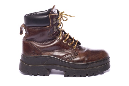 Close up view some old hiking boots isolated on a white background.