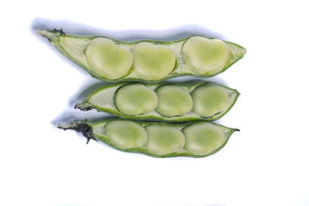 Close up view of some broad beans isolated on a white background.