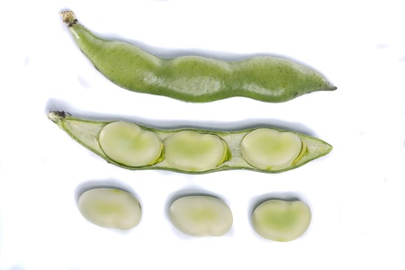 Close up view of some broad beans isolated on a white background.