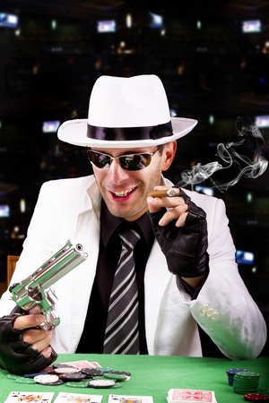 View of a gangster man playing some cards and poker, smoking a Cuban cigar.のeditorial素材