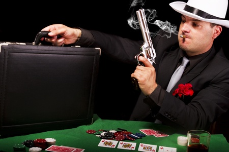 View of a white suit gangster man holding a gun and a briefcase.のeditorial素材