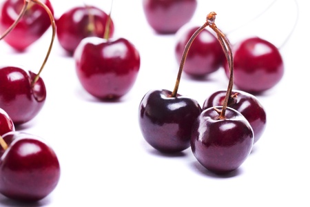 Close detail view of a bunch of red cherries isolated on a white background.の写真素材