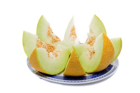Close detail view of some sliced Cantaloupe melons isolated on a white background.の写真素材