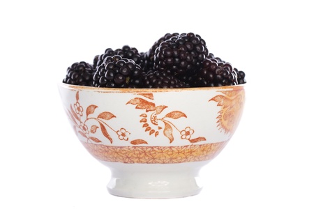Close view detail of some blackberries isolated on a white background.