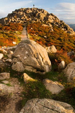 View of a landscape featuring a pile of rocks on top of Monchique mountain in Portugal.
