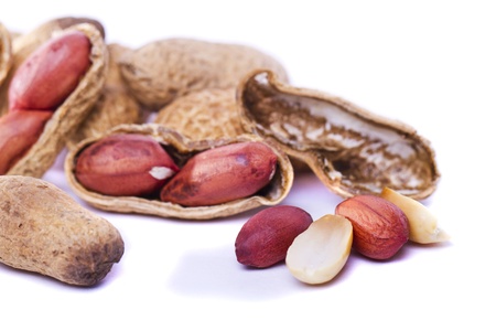 Close view detail of a bunch of peanuts on a white background.