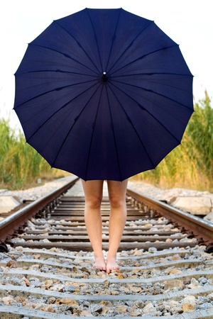View of a beautiful girl with a spring dress on a railway.の写真素材