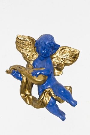 Close view detail of a blue angel with golden wings isolated on a white background.