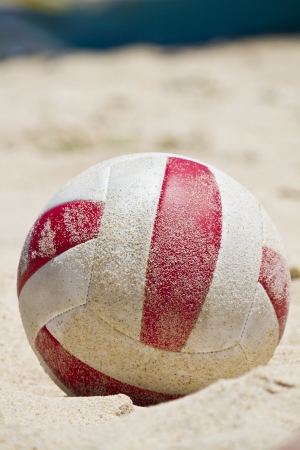 Close view detail of a beach ball covered in sand on a beach.の写真素材