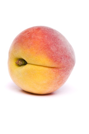 Close view of a tasty peach isolated on a white background.の写真素材