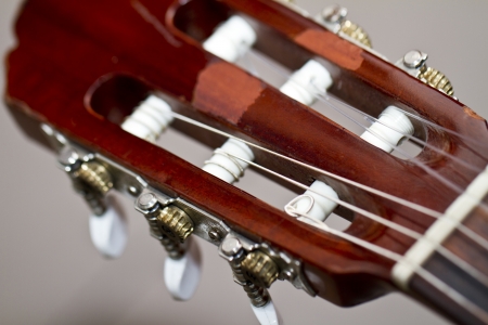 Close up view detail of the head neck of a classic acoustic guitar.の写真素材