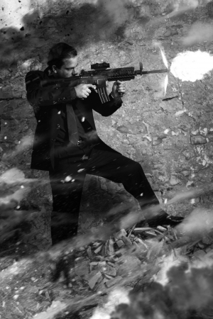 View of a contracted type killer agent wandering with a jacket and machine gun.