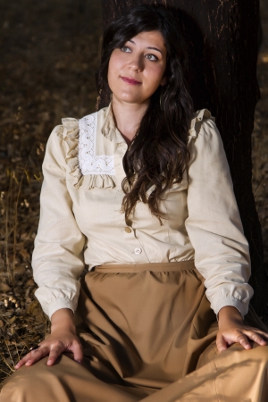 View of a beautiful girl in classic dress wandering on the countryside.の写真素材