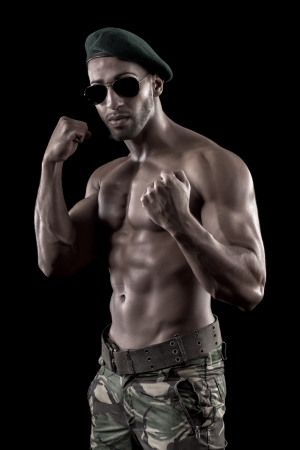 View of a muscled man on a black background in artistic, fitness and bodybuilding poses.の写真素材