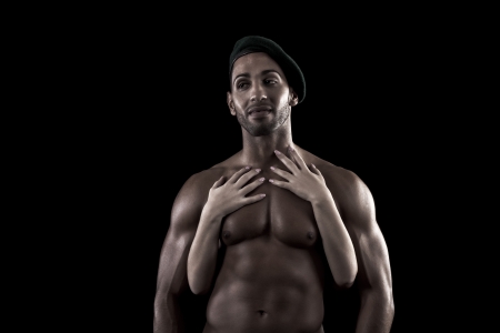 View of a muscled man on a black background in artistic, fitness and bodybuilding poses.の写真素材