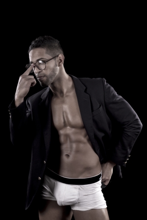 View of a muscled man on a black background in artistic, fitness and bodybuilding poses.の写真素材