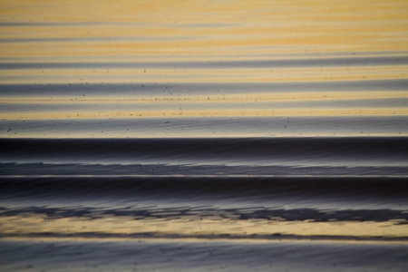 View of beautiful lines of water ripples on the morning water.の写真素材