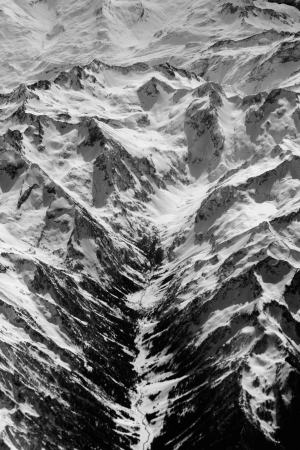 Aerial view of snowy mountains seen from a plane.の写真素材